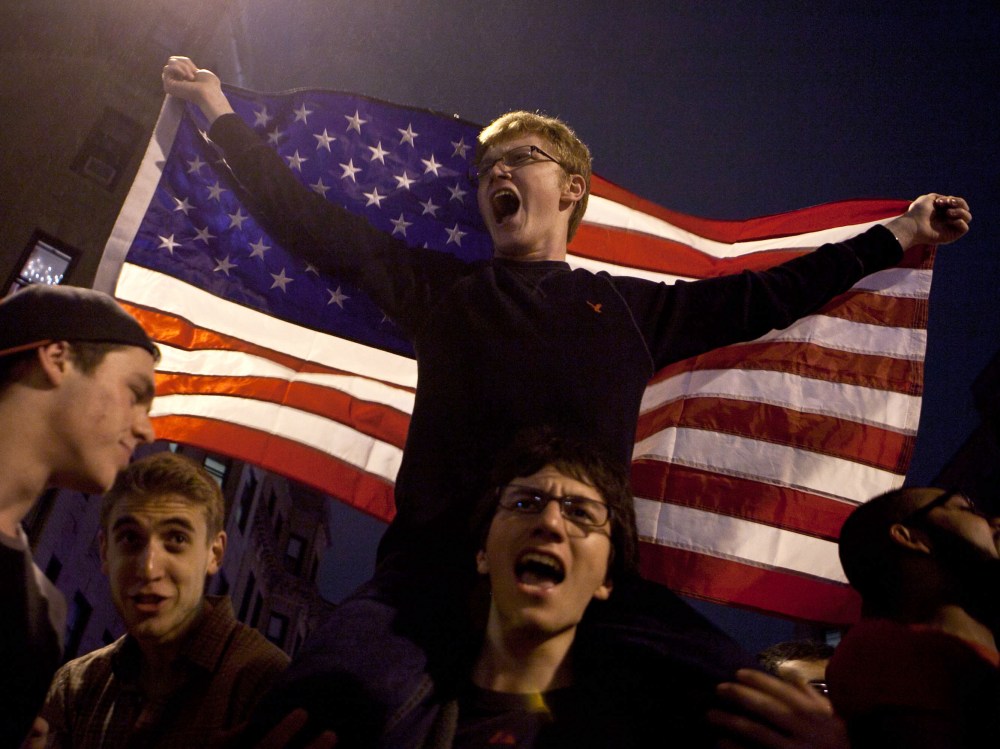 A few of the estimated 200 people who poured onto Hemingway Street in the Fenway neighborhood to celebrate after the announcement earlier of the capture of the second  Boston Martathon bombing suspect celebrate April 19, 2013 in Boston, Massachusetts....