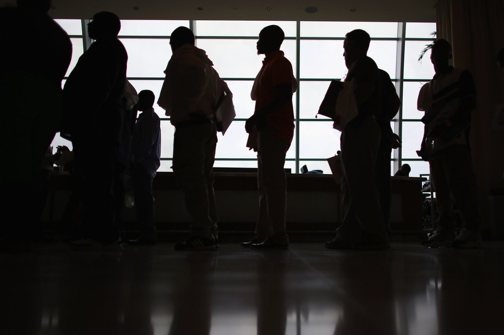People looking for work stand in line to apply for a job during a job fair in Miami, Fla. (Photo by Joe Raedle/Getty)