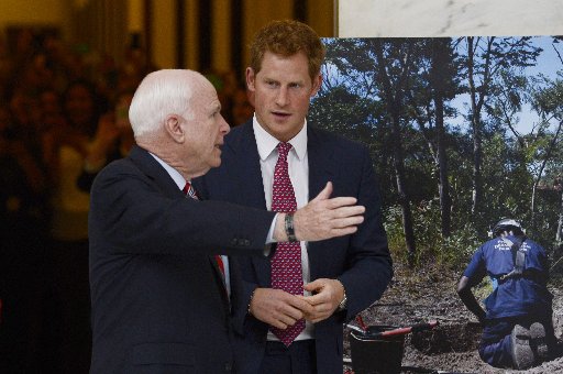 WASHINGTON, DC - MAY 09: Prince Harry (R) tours a HALO Trust photo exhibit on landmines and unexploded ordinances, with Republican Senator from Arizona John McCain (L), on Capitol Hill on May 9, 2013 in Washington, DC.(Photo by Michael Reynolds-Pool...