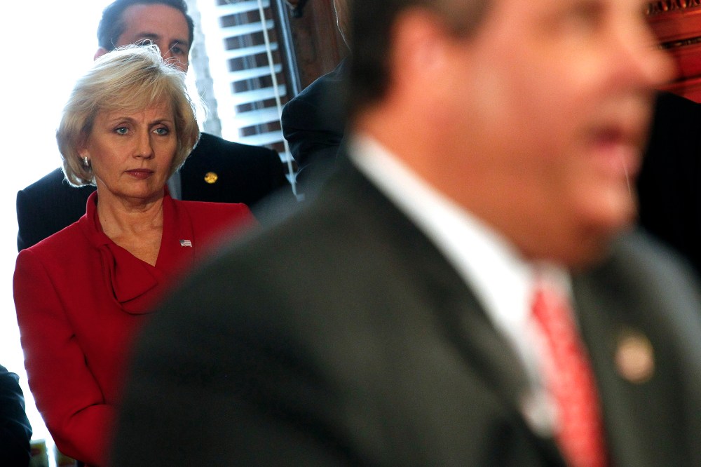 New Jersey Lt. Gov. Kim Guadagno looks on as New Jersey Gov. Chris Christie speaks in Trenton on June 4, 2013.