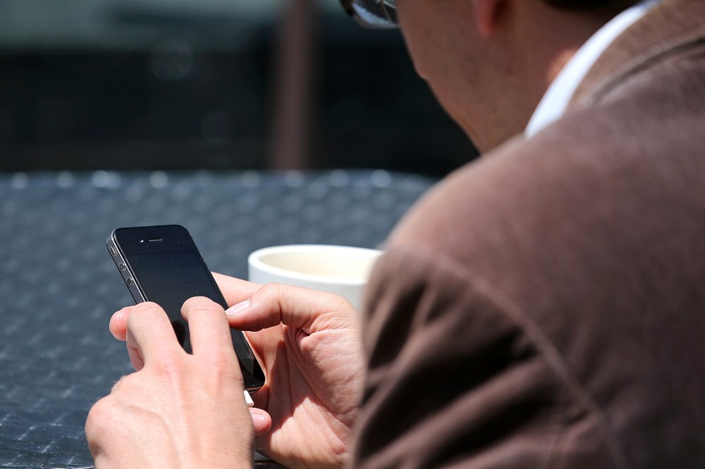 A man uses a smartphone in San Francisco, Calif., June 5, 2013.