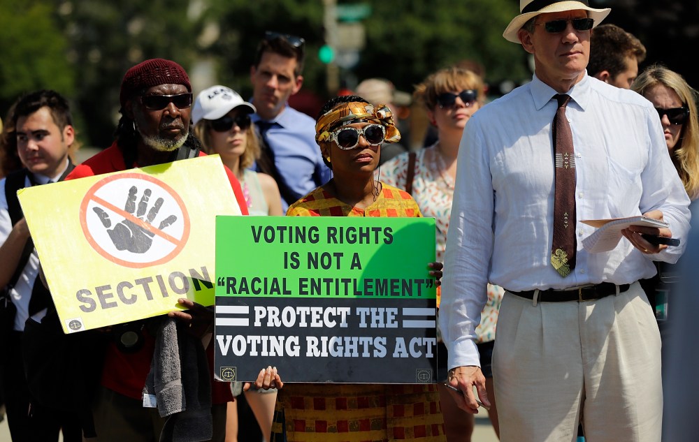 Supporters of the Voting Rights Act listen to speakers discussing today's rulings outside the U.S. Supreme Court building on June 25, 2013 in Washington, DC. (Photo by Win McNamee/Getty Images)