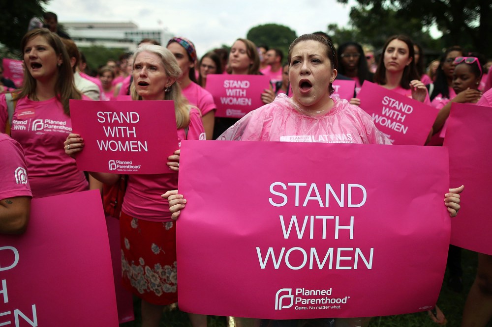 Women hold up signs during a women's pro-choice rally on Capitol Hill, July 11, 2013 in Washington, DC.