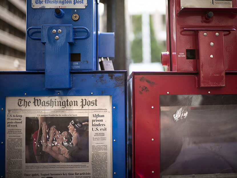 A Washington Post newspaper box (L) stands beside the empty box of competitor Washington Times (R) outside the Washington Post on August 5, 2013 in Washington, DC, after it was announced that Amazon.com founder and CEO Jeff Bezos had agreed to purchase...