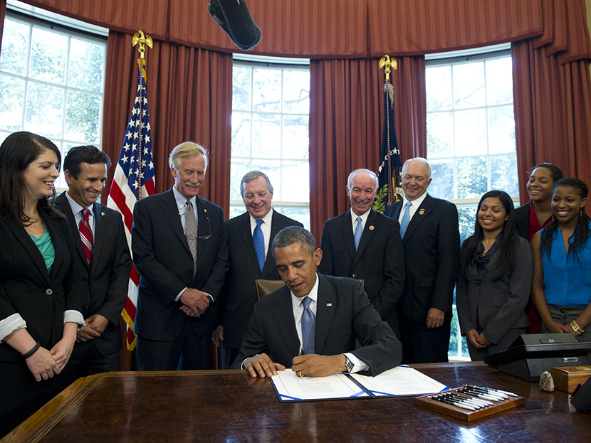 US President Barack Obama signs a student loan bill to keep students' interest rates low during a signing ceremony in the Oval Office of the White House in Washington, DC, on Aug. 9, 2013. (Photo by Saul Loeb/AFP/Getty)