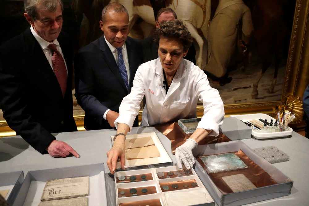 Museum of Fine Arts Boston Head of Objects Conservation Pam Hatchfield, right, displays objects removed a time capsule, Jan. 6, 2015. (Photo by Steven Senne/AP)
