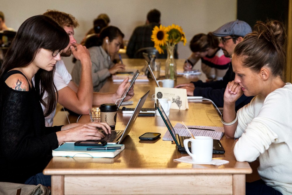 Customers work on their laptops at Great Lakes Coffee Roasting Company on September 6, 2013 in Detroit, Michigan.