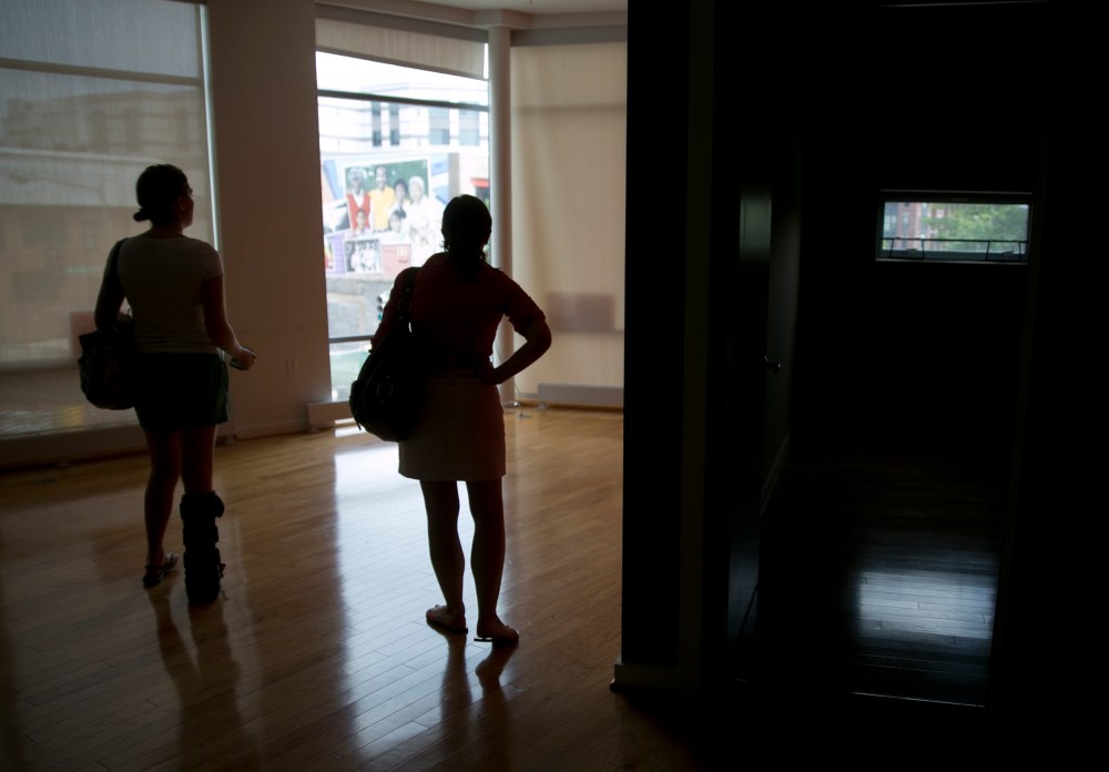 Image: Potential homebuyers look at a condominium for sale in Washington