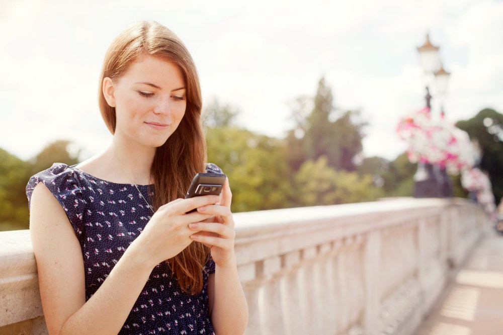 Image: A woman uses a mobile phone