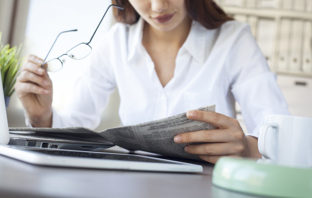 Image: woman reading newspaper