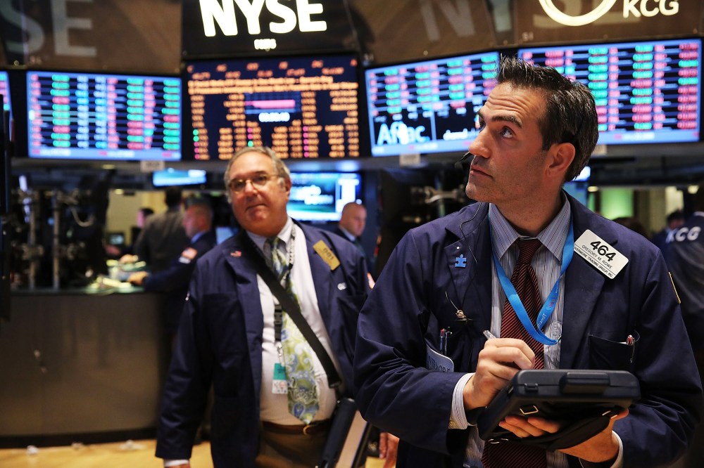 Traders work on the floor of the New York Stock Exchange minutes before the closing bell on October 8, 2013 in New York City.