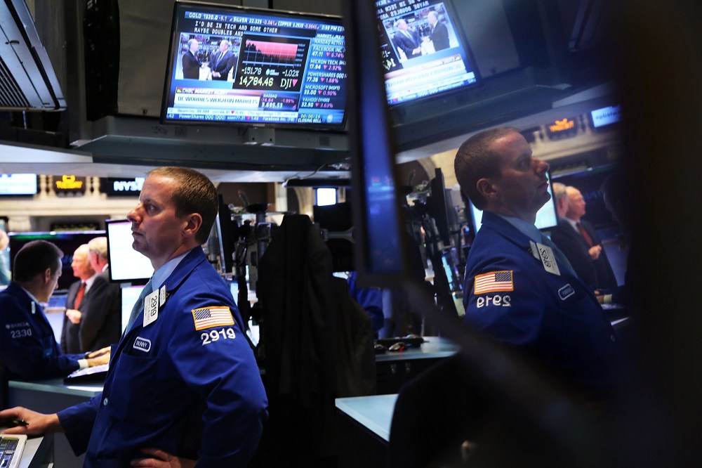 Traders work on the floor of the New York Stock Exchange minutes before the closing bell on October 8, 2013 in New York City.