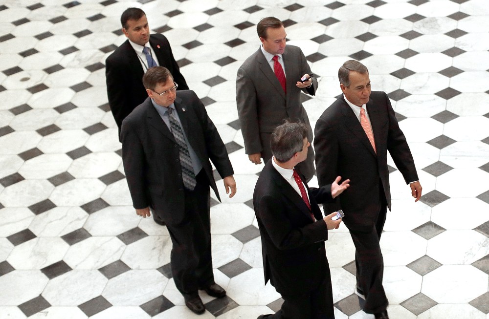 Speaker of the House John Boehner (R-OH) (R) walks from the House floor following a vote on Oct. 10, 2013 in Washington, DC.
