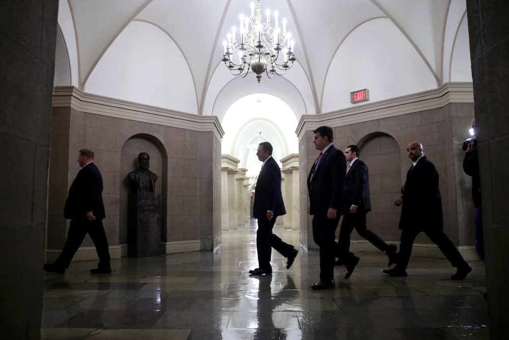 Speaker of the House John Boehner is surrounded by U.S. Capitol Police plainclothes officers as he arrives at the U.S. Captiol October 11, 2013 in Washington, DC.