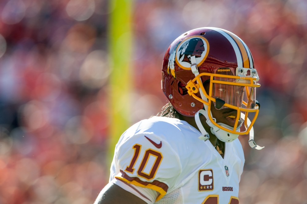 Quarterback Robert Griffin III of the Washington Redskins runs onto the field before a game against the Denver Broncos on October 27, 2013 in Denver, Colorado.