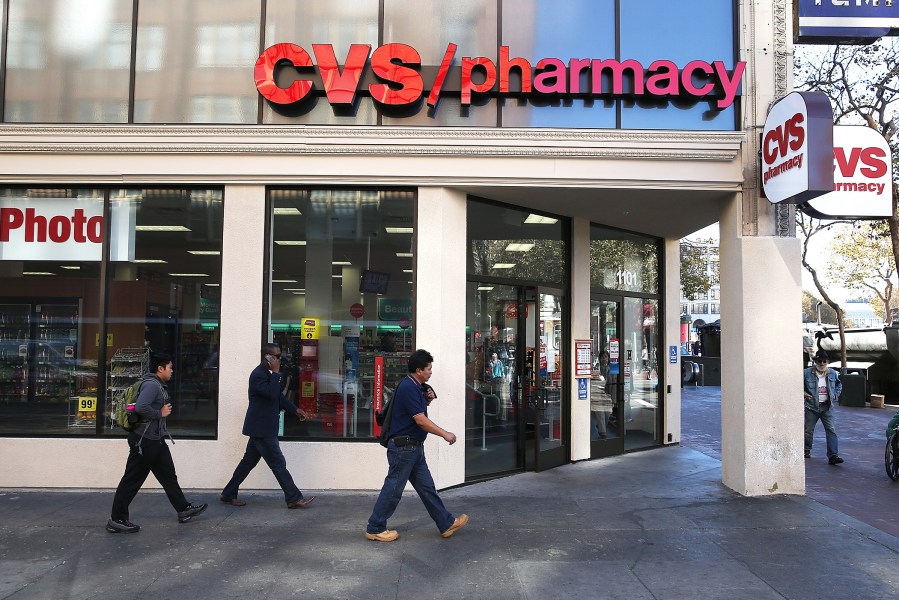 Pedestrians walk by a CVS store in San Francisco, Calif., Nov. 5, 2013.