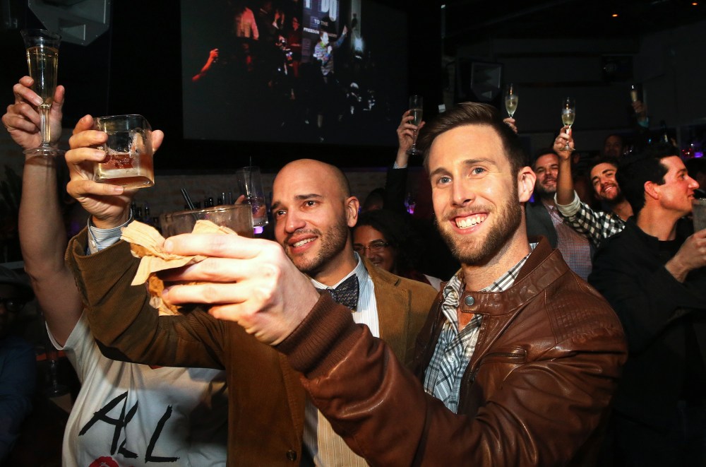 Fernando Mojica and Drew Freeman raise a toast in celebration of the Illinois General Assembly's approval of a gay marriage bill on November 5, 2013 in Chicago, Illinois.
