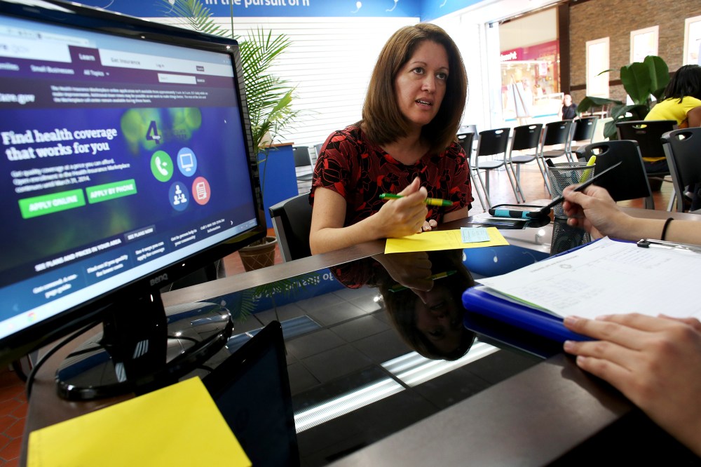 Venita Mendez looks to purchase an ACA insurance policy in Hialeah, Florida, Nov. 14, 2013.