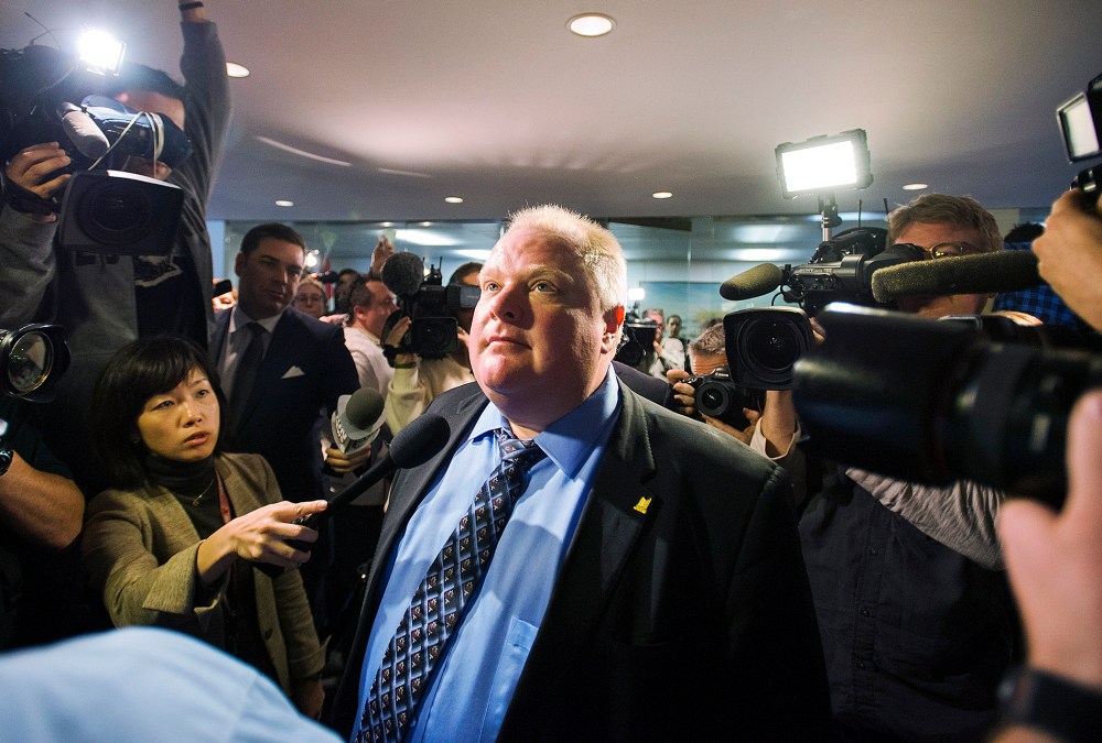 Toronto Mayor Rob Ford stands amid the media at City Hall after City Council some management powers on Nov.15, 2013 in Toronto, Canada.