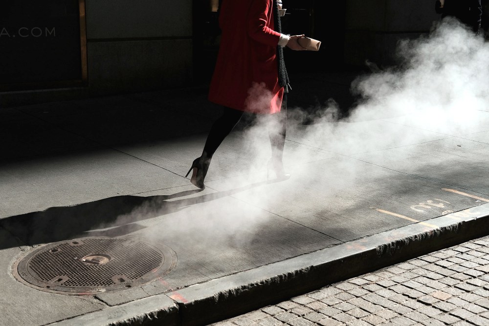 Image:  A woman walks on Wall Street in New York on March 21, 2016.