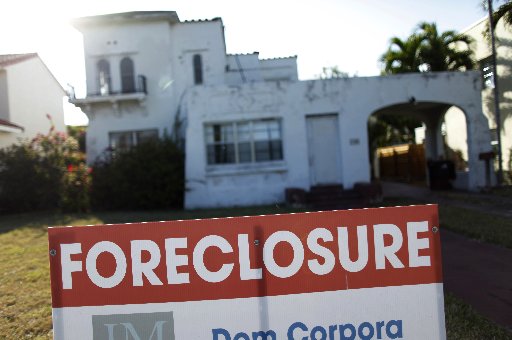 A foreclosure sale sign sits in front of a house in Miami Beach, Florida in this file photo taken February 27, 2009.  (REUTERS/Carlos Barria/Files)