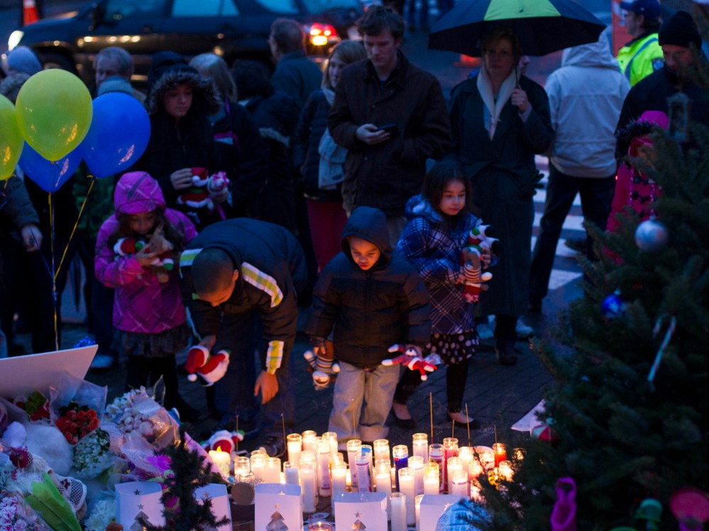 Mourners place candles and stuffed toy animals on a memorial for victims of the recent mass shooting in Newtown, Connecticut December 16, 2012. (Photo by Lucas Jackson/Reuters)