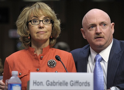 Former Arizona Rep. Gabrielle Giffords sits with her husband Mark Kelly, on Jan. 30, 2013, and gives an opening statement before the Senate Judiciary Committee hearing on gun violence. (Photo by Susan Walsh/AP Photo)