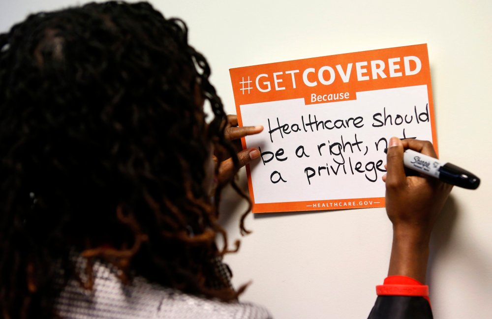 A woman fills out her thoughts on the Affordable Care Act at the White House Youth Summit on the Affordable Care Act in Washington, December 4, 2013.