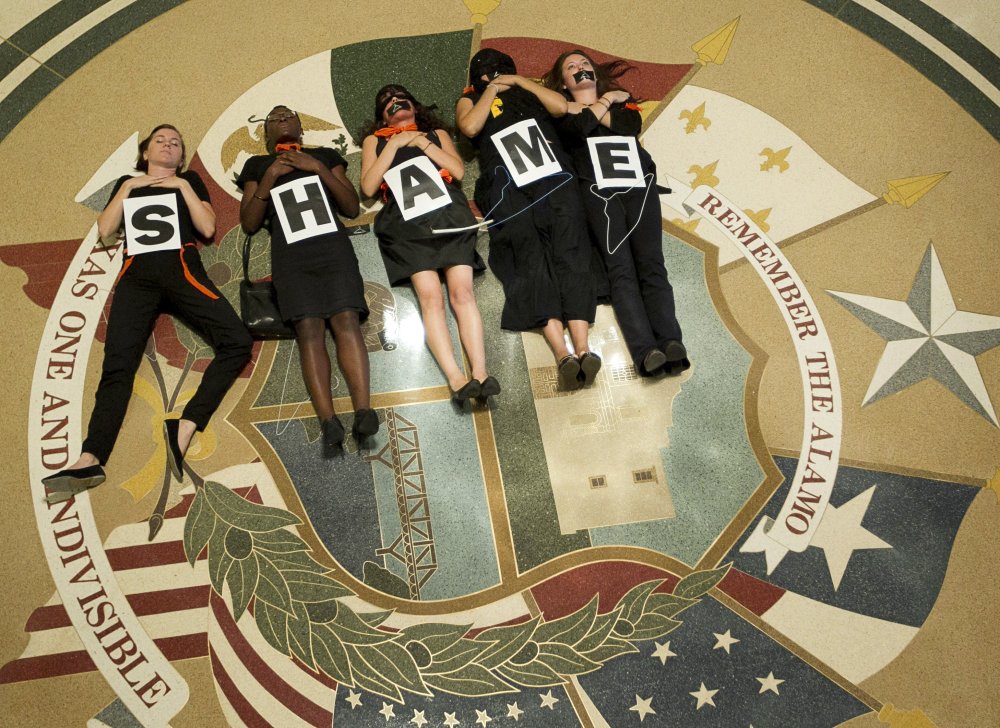 July 18, 2013 - Austin, Texas, U.S. - Abortion rights supporters demonstrate outside the Capitol auditorium where Gov. R. Perry signed the abortion restriction bill that will outlaw abortions after 20 weeks and force abortion clinics and doctors to...