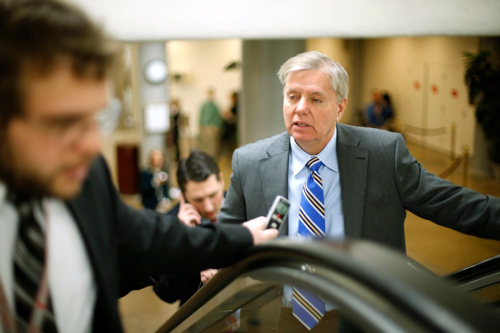 Senator Lindsey Graham (R-SC) (R) talks to reporters as he arrives for the weekly Republican caucus luncheon at the U.S. Capitol in Washington, February 4, 2014.