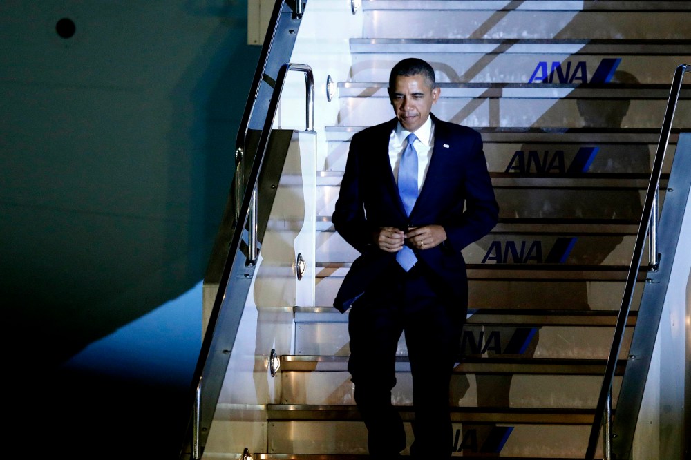 U.S. President Barack Obama walks down the steps of Air Force One as he arrives at Haneda International Airport in Tokyo on April 23, 2014.