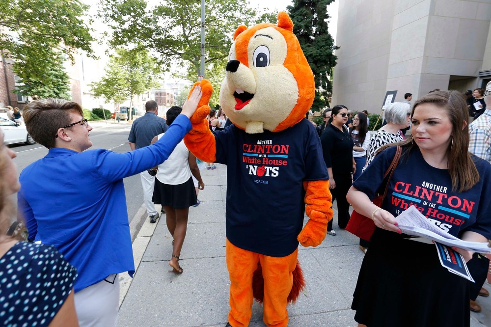 A Republican intern in a squirrel costume and a T-shirt that reads, "Another Clinton in the White House is Nuts"