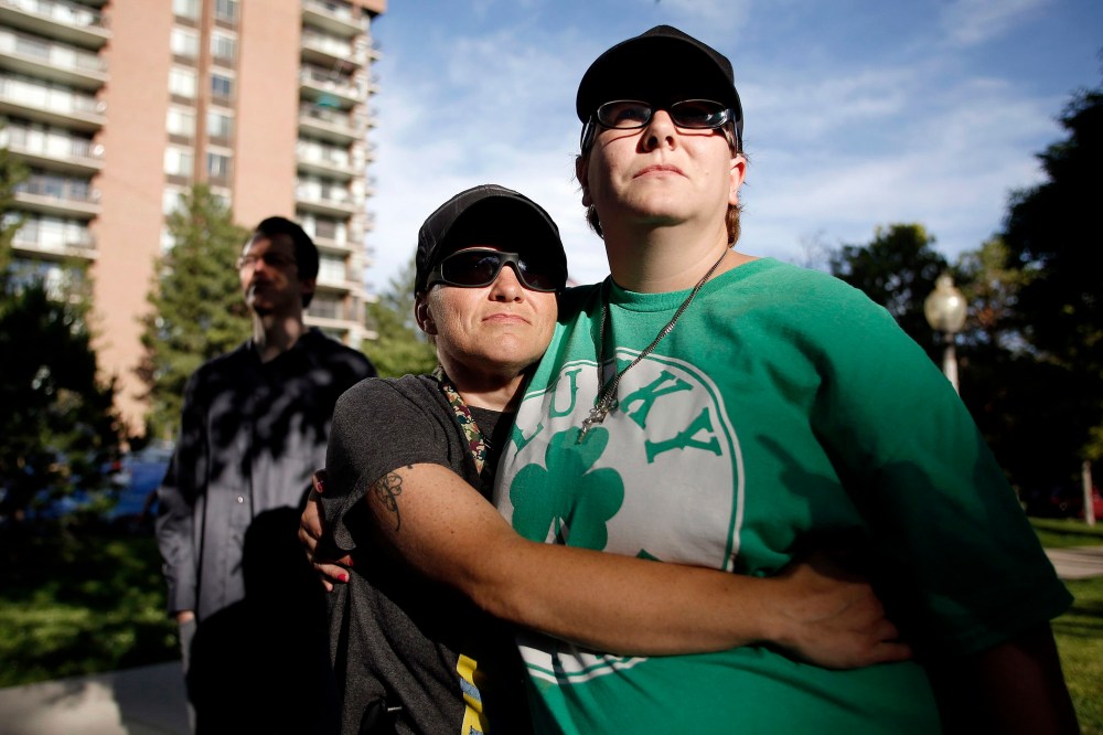 Laura Greenwood (L) and her partner Erin McLaughlin listen during a same-sex marriage rally to celebrate the 10th Circuit Court of Appeals decision in Salt Lake City, Utah, June 25, 2014.