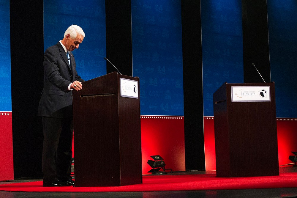 Former Florida Governor and challenger, Charlie Crist, appears alone for the first few minutes of a their gubernatorial debate, as Florida Governor Rick Scott delays taking the stage on Oct. 15, 2014.