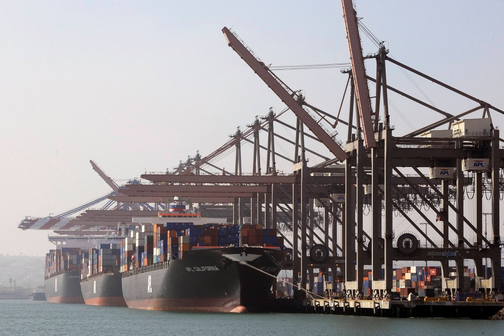 Freighters and cargo containers sit idle at the Port of Los Angeles as a back-log of over 30 container ships sit anchored outside the Port in Long Beach, Calif. on Feb. 18, 2015.