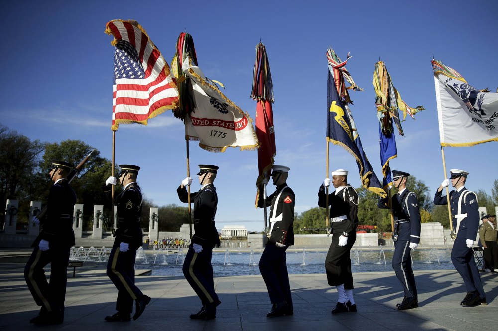 The U.S. military honor guard removes the colors at the National World War II Memorial on Veteran's Day to pay tribute to the more than 16 million men and women who served with U.S. armed forces during World War II in Washington, D.C., on Nov. 11, 2015.