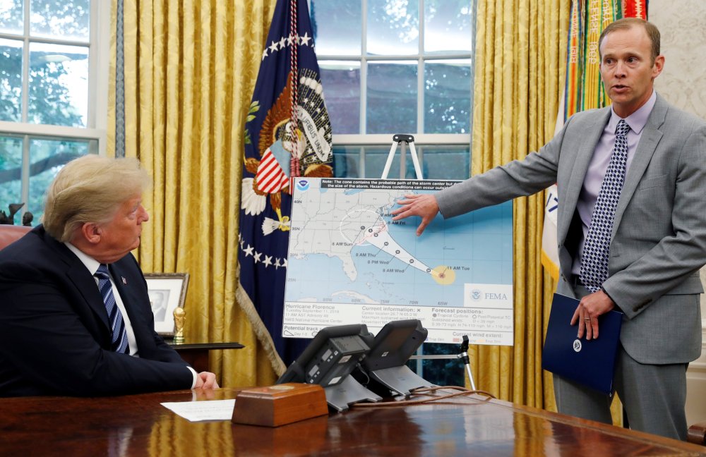 U.S. President Donald Trump holds an Oval Office meeting on hurricane preparations as FEMA Administrator Brock Long points to the potential track of Hurricane Florence on a graphic at the White House in Washington, U.S., September 11, 2018.