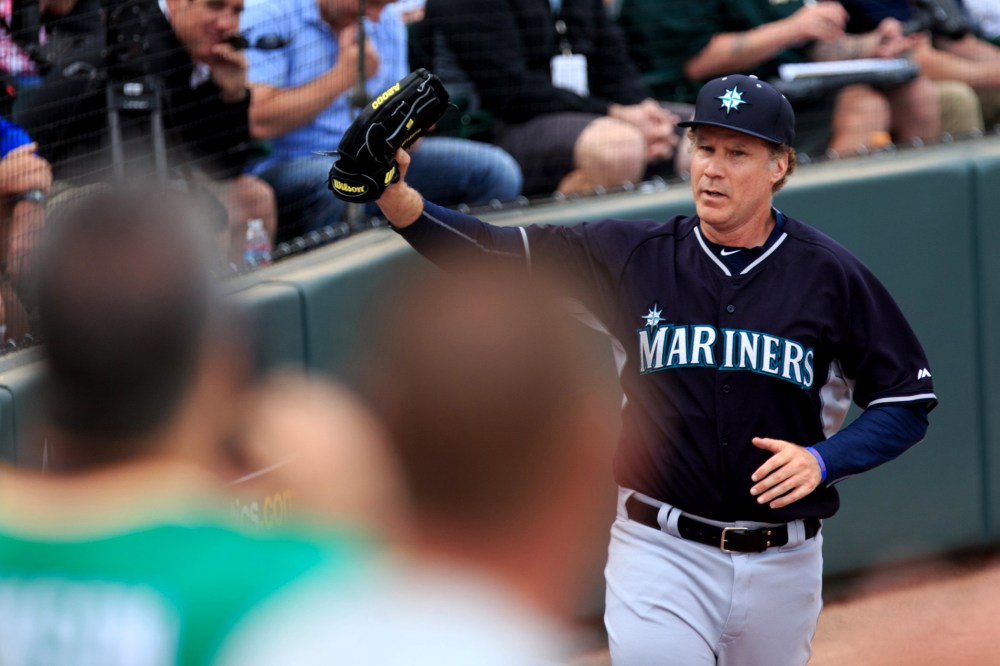 Will Ferrell waves to fans as he leaves the field after playing infield for the Seattle Mariners a spring training game against the Oakland Athletics at HoHoKam Stadium in Mesa, Ariz. on March 12, 2015.