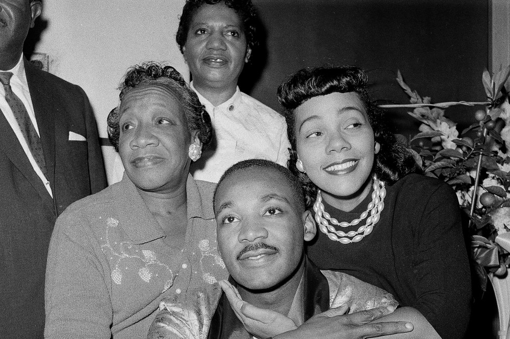 Dr. Martin Luther King, Jr., is embraced by his wife Coretta Scott King during a news conference at Harlem Hospital in New York, Sept 30, 1958. At left is his mother, Alberta Williams King.