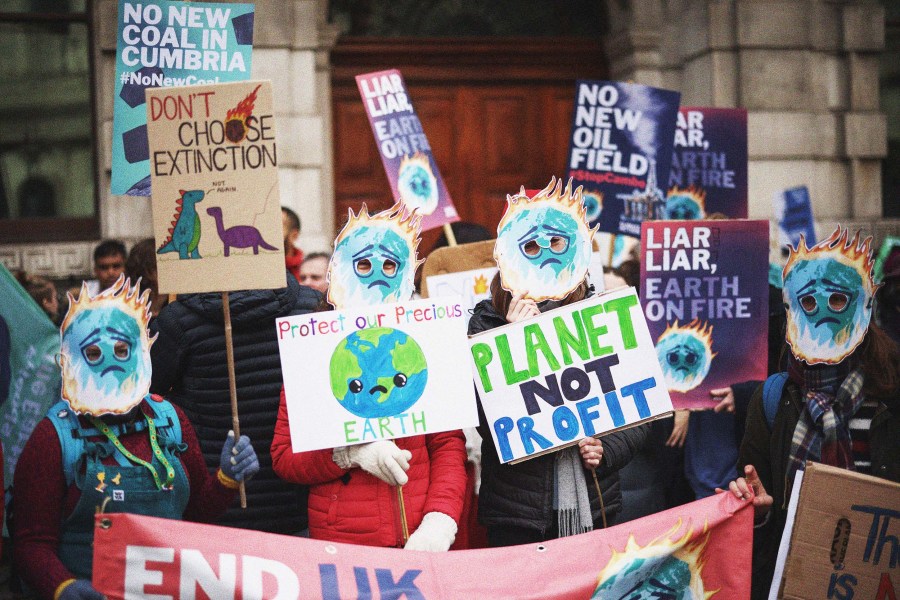 Demonstrators wearing masks participate in a protest in London as the UN Climate Change Conference (COP26) took place in Glasgow, Scotland