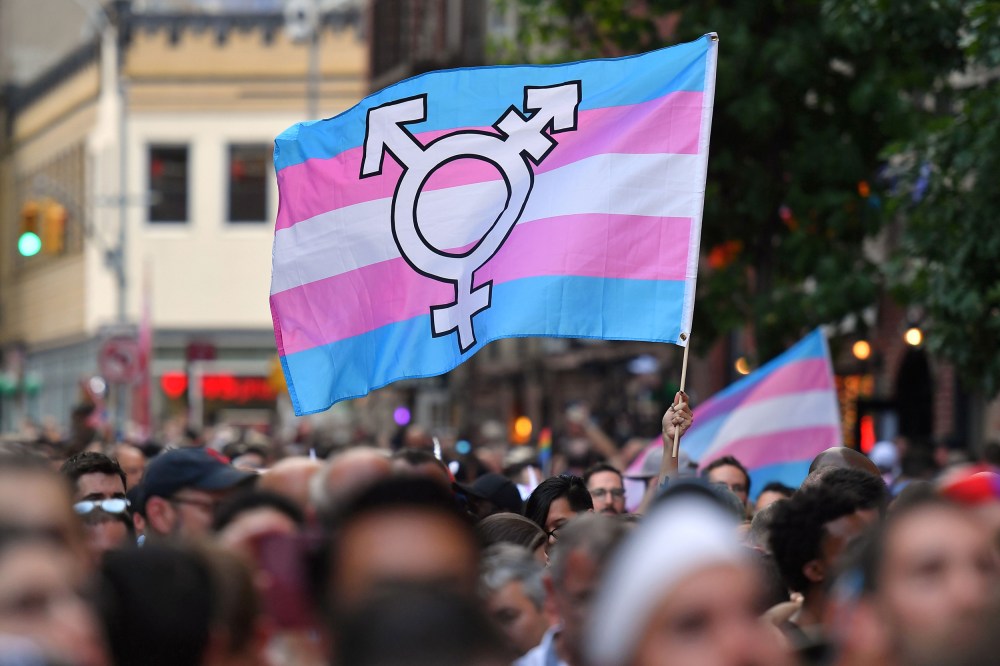 A transgender pride flag is waved outside the Stonewall Inn in New York in 2019.