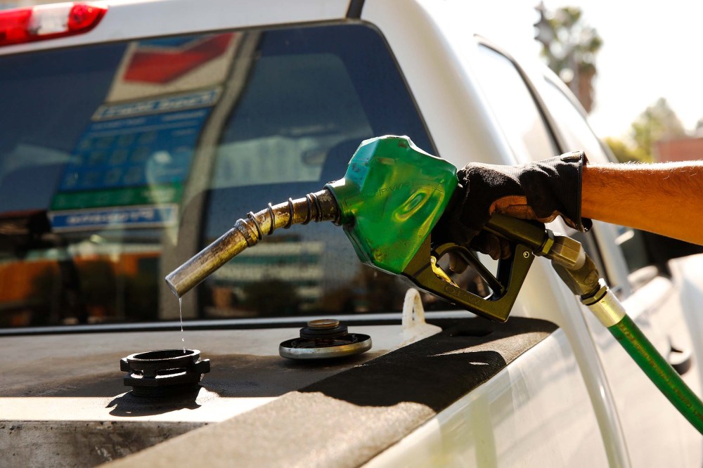 A driver fills up their tank at a Chevron Gas Station in downtown Los Angeles in November 2021, when gas prices hit an average price of $4.676, the highest recorded average price for regular gasoline, according to AAA.