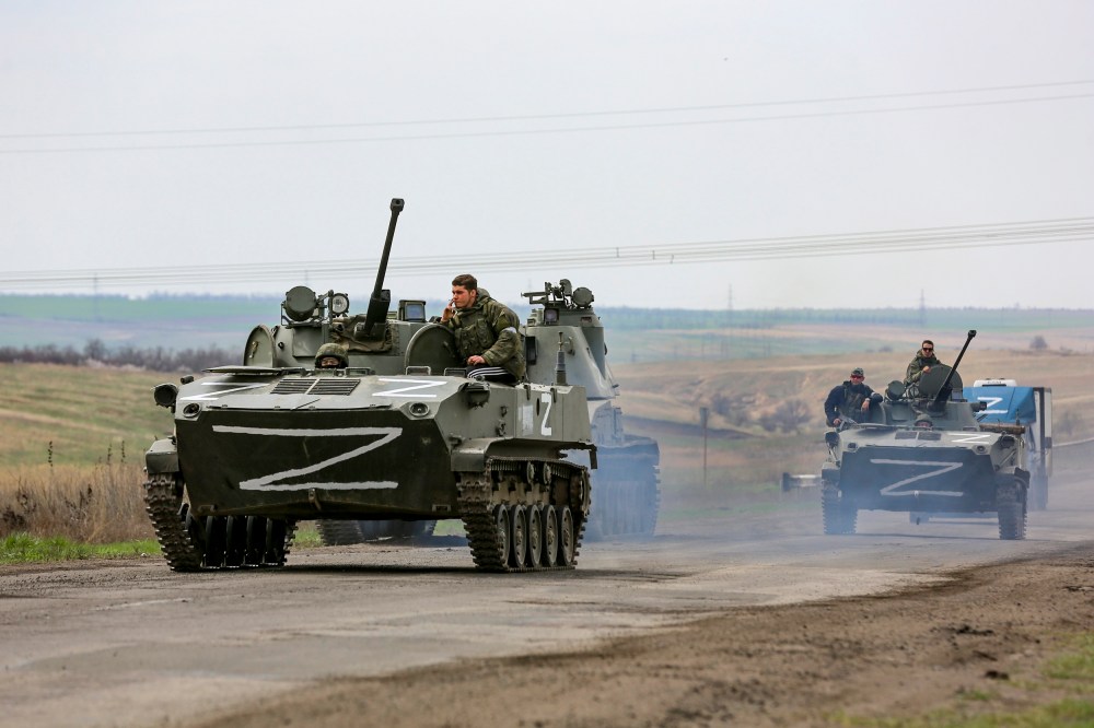 Russian military vehicles move on a highway in an area controlled by Russian-backed separatist forces near Mariupol, Ukraine, on April 18, 2022.