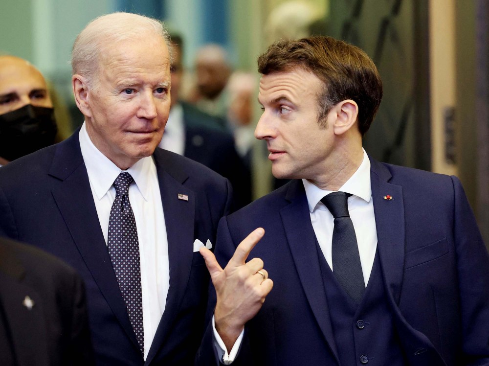 President Joe Biden speaks with France's President Emmanuel Macron ahead of an extraordinary NATO summit at NATO Headquarters in Brussels on March 24.