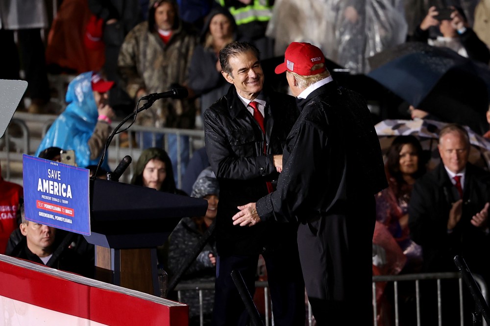 Image: Senate candidate Mehmet Oz and former President Donald Trump shake hands at a rally in Greensburg, Pa., on May 6, 2022.