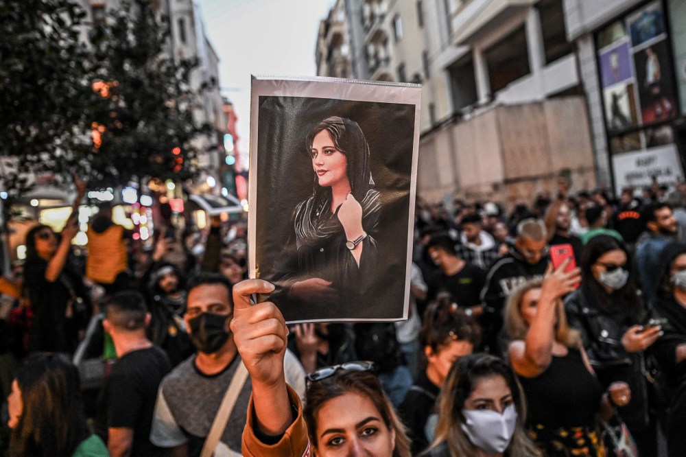 Image: A protester holds a portrait of Mahsa Amini during a demonstration in support of Amini in Istanbul