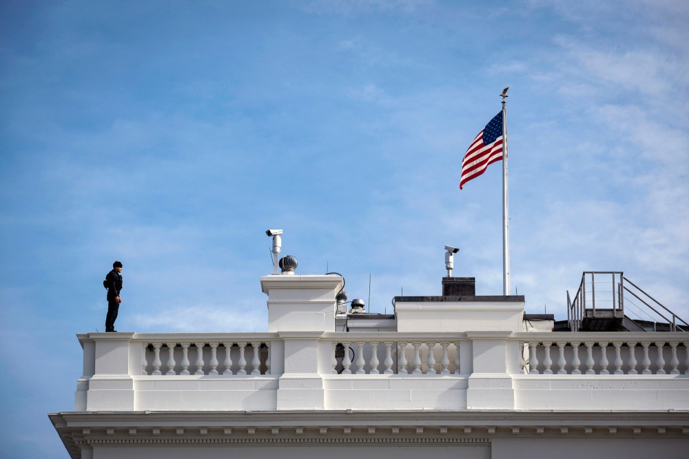 Image: A Secret Service agent stands guard on the roof of the White House in Washington in 2020.
