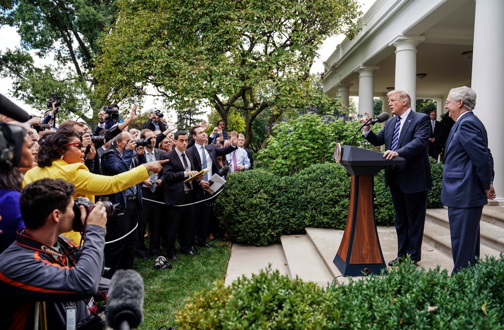 April Ryan, left, the Washington bureau chief for American Urban Radio Networks asks questions to President Donald Trump and Senate Majority Leader Mitch McConnell of Ky., in the Rose Garden of the White House on Oct. 16, 2017.