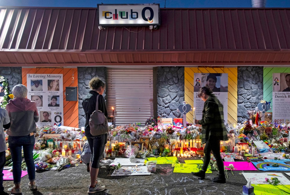 Mourners gather at a memorial for the victims of a mass shooting at Club Q