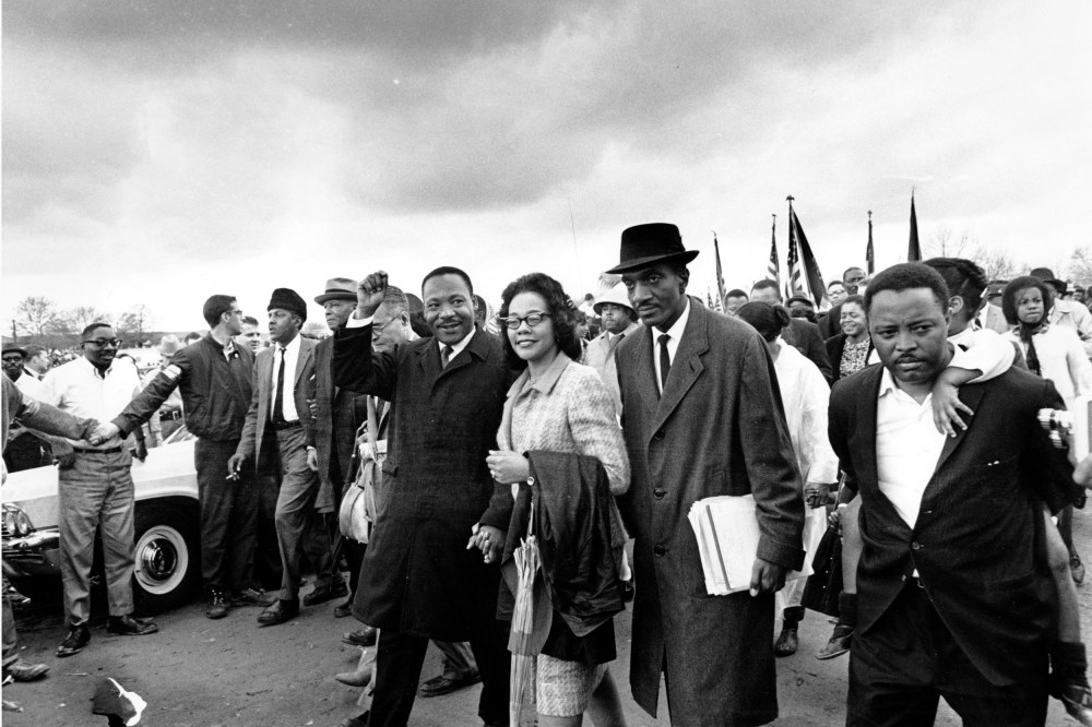 Dr. Martin Luther King Jr., and his wife, Coretta Scott King, lead off the final lap to the state capitol at Montgomery, Ala., on March 25, 1965. Thousands of civil rights marchers joined in the walk, which began in Selma, Ala., on March 21, demanding voter registration rights for blacks. Rev. D.F. Reese, of Selma, is at right. (AP Photo)